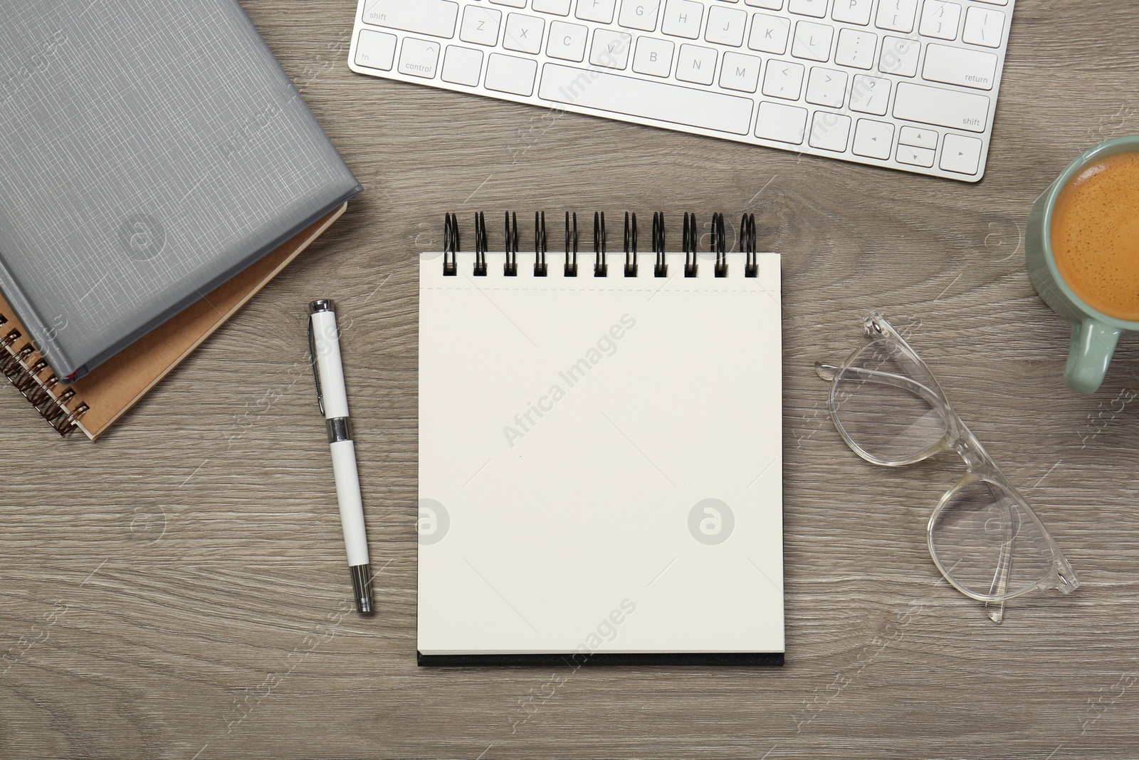 Photo of Flat lay composition with notebooks on wooden table