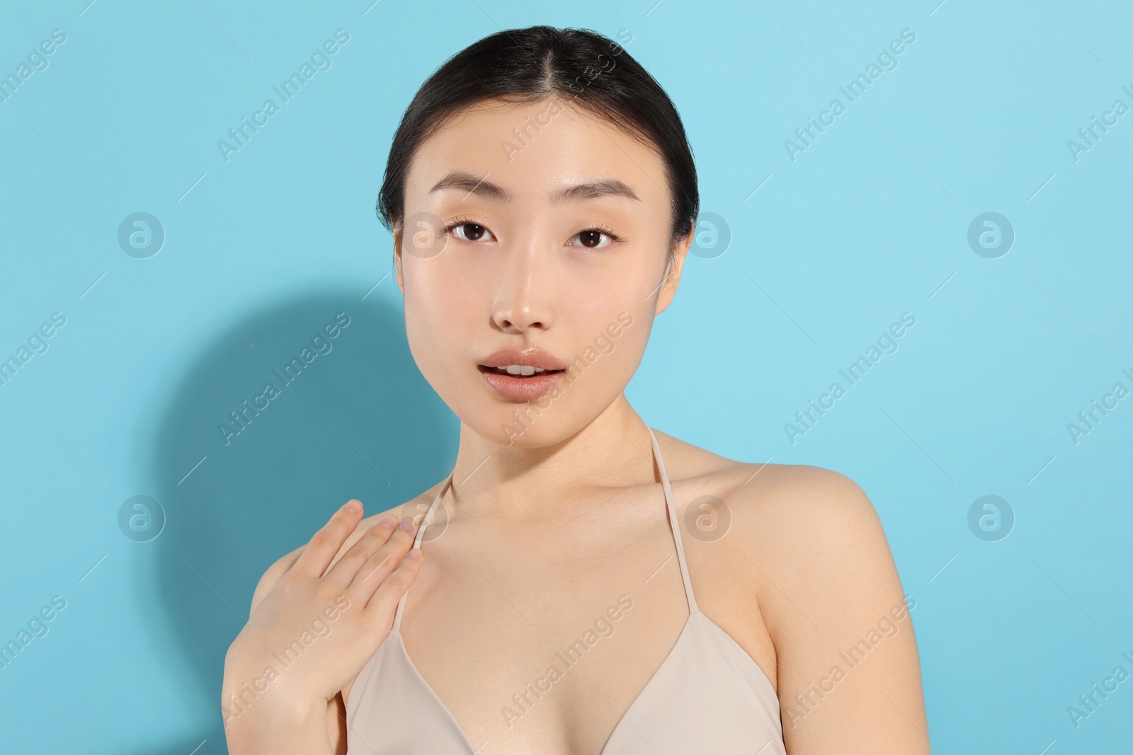 Photo of Beautiful young woman on light blue background