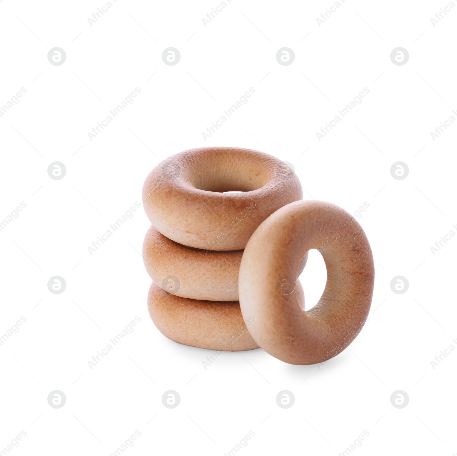 Photo of Stack of tasty dry bagels (sushki) on white background