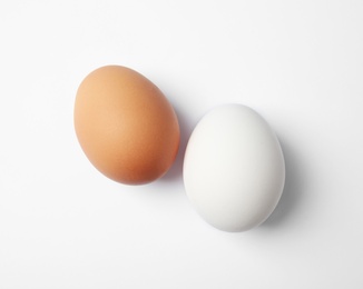 Raw chicken eggs on white background, top view