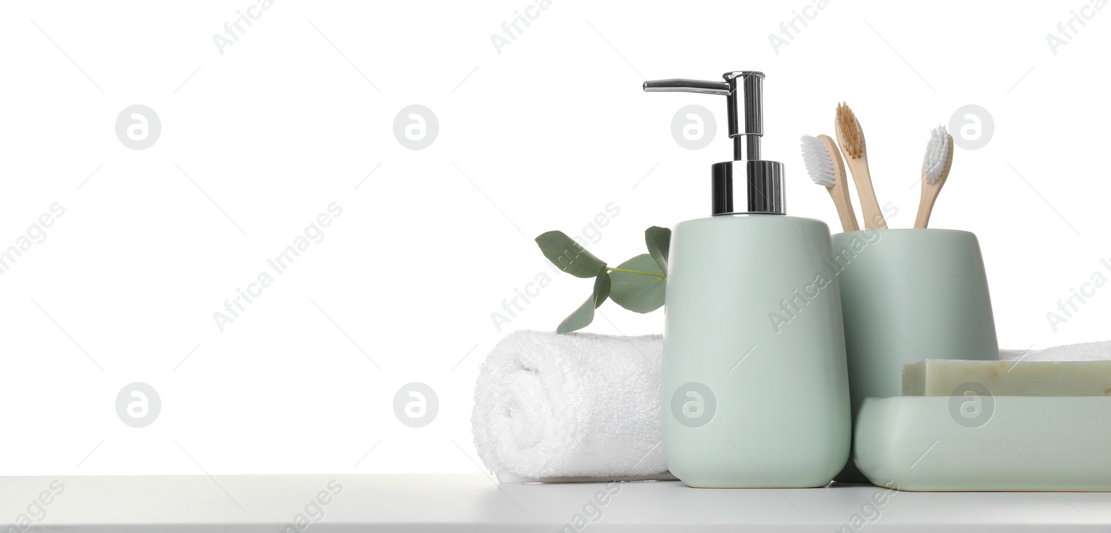 Photo of Bath accessories. Different personal care products and eucalyptus branch on table against white background. Space for text