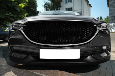 Car with vehicle registration plate outdoors. Mockup for design