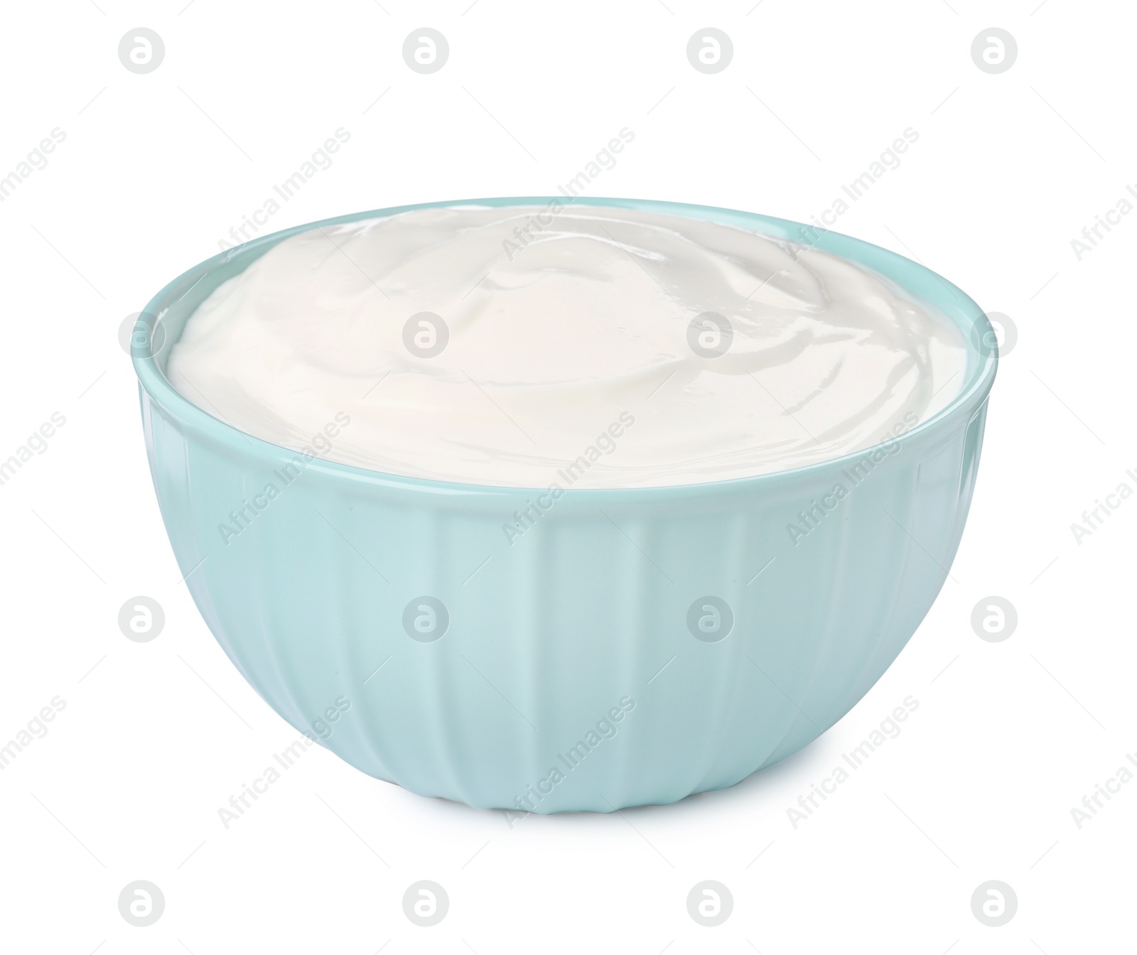 Photo of Bowl with delicious organic yogurt isolated on white