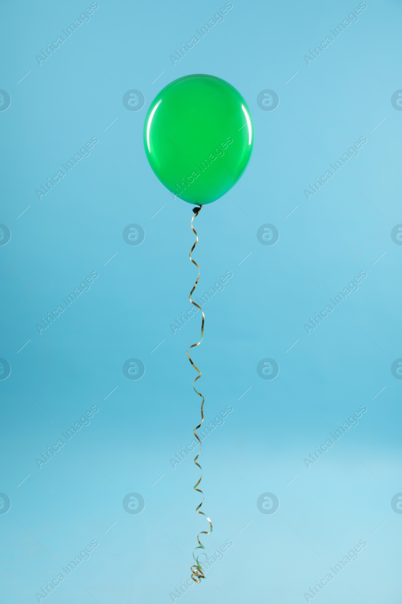 Photo of Bright balloon on color background. Celebration time