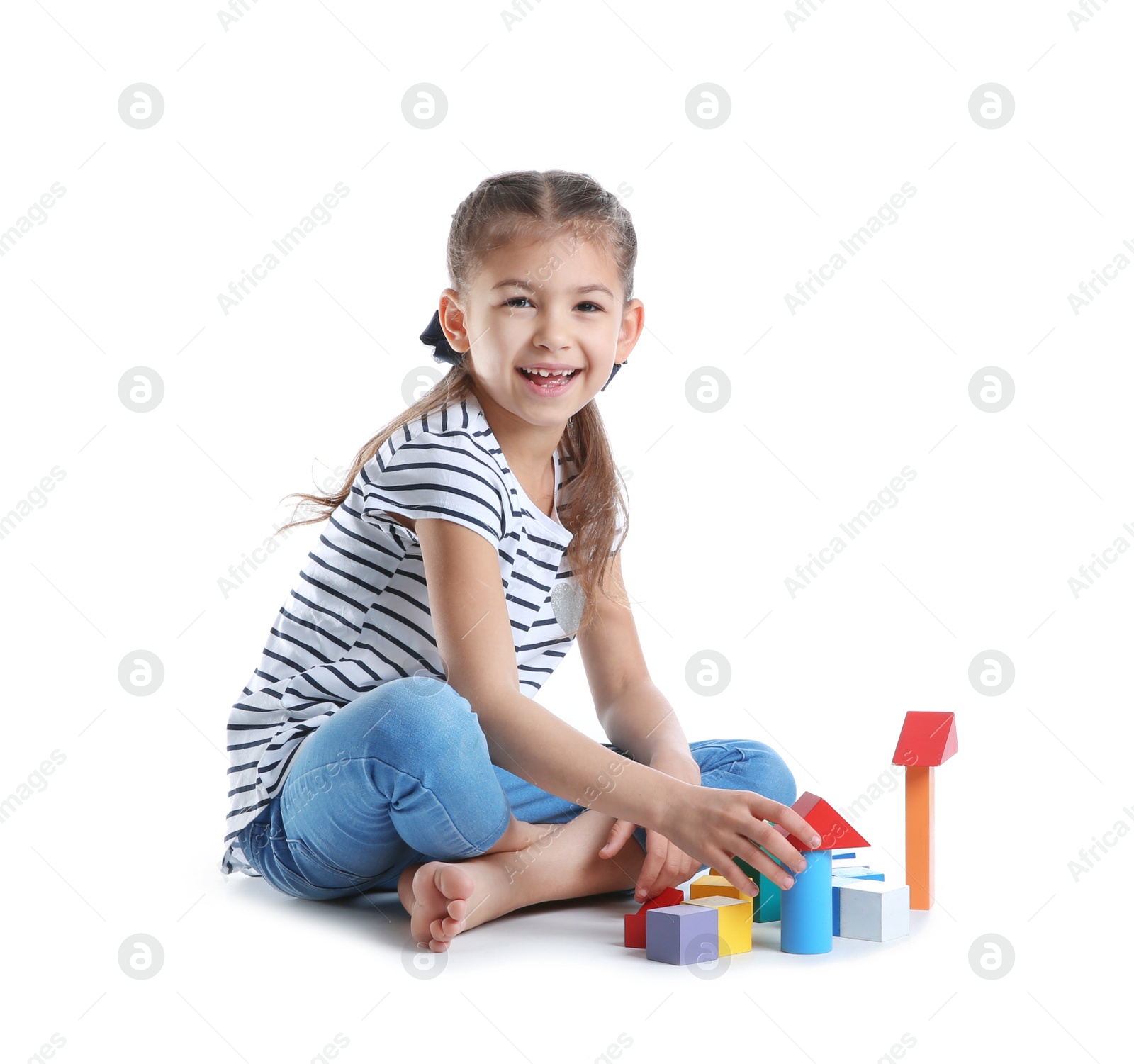 Photo of Cute child playing with colorful blocks on white background