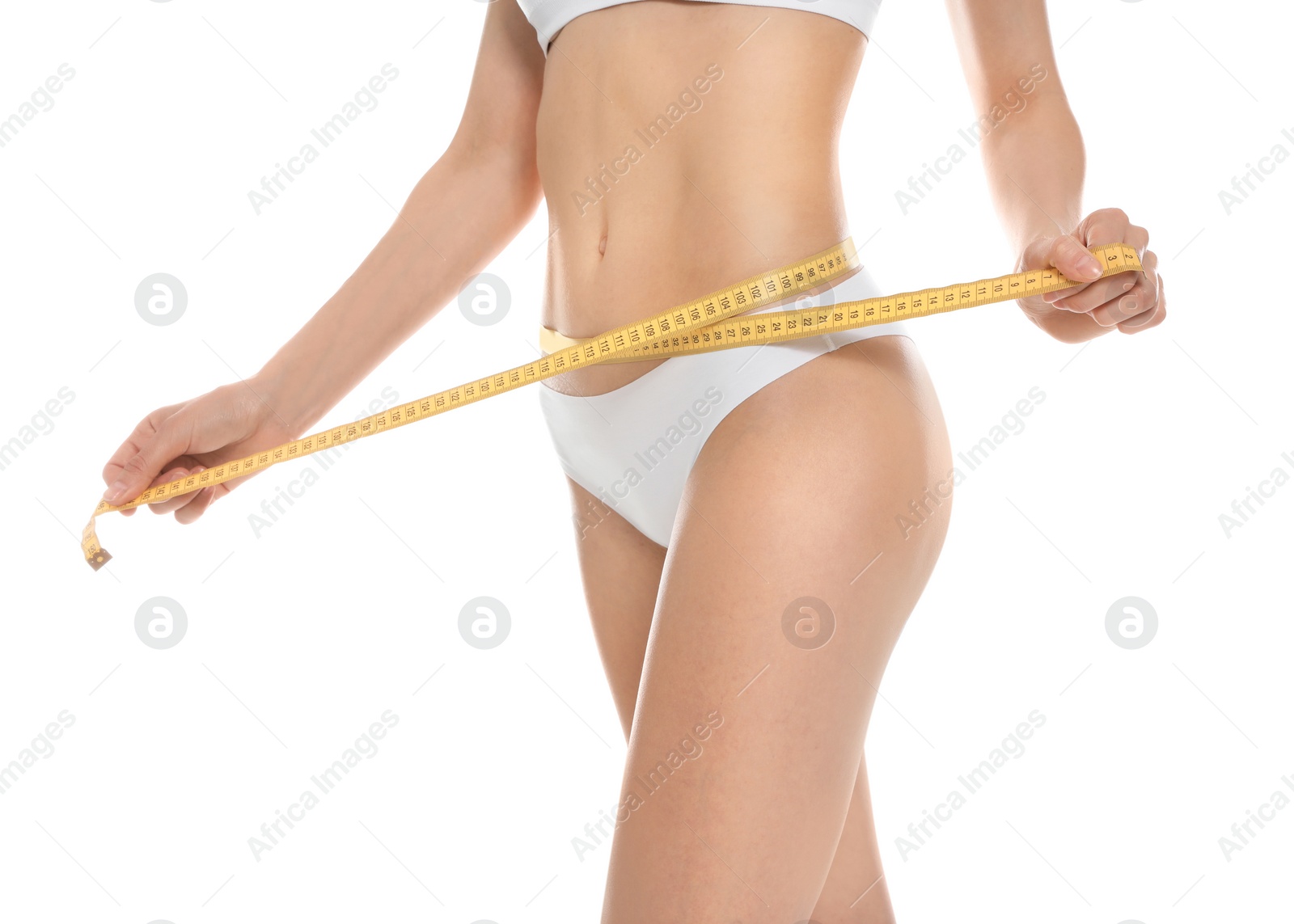 Photo of Slim young woman with smooth gentle skin in underwear measuring body on white background, closeup