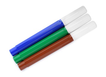 Different colorful markers on white background, top view