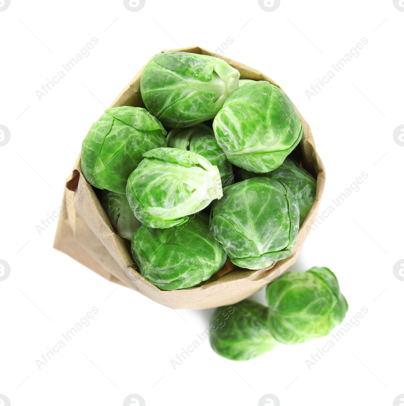 Photo of Fresh Brussels sprouts in paper bag on white background, top view