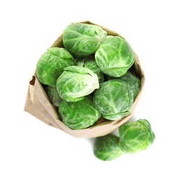 Photo of Fresh Brussels sprouts in paper bag on white background, top view