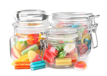 Tasty jelly candies in jars on white background