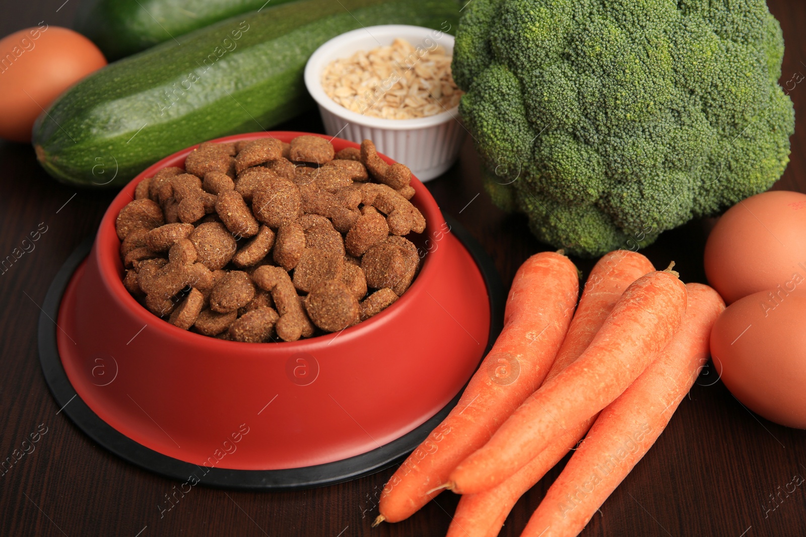 Photo of Dry pet food and products on wooden background