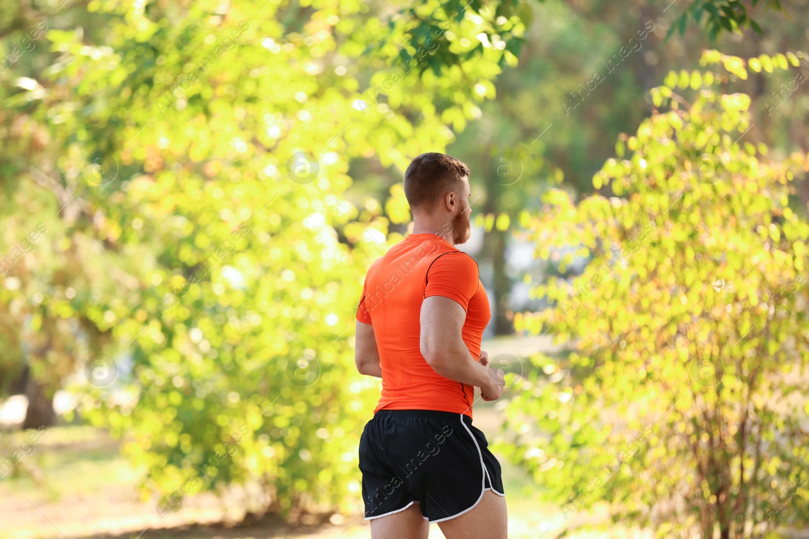 Photo of Young man running in park on sunny day