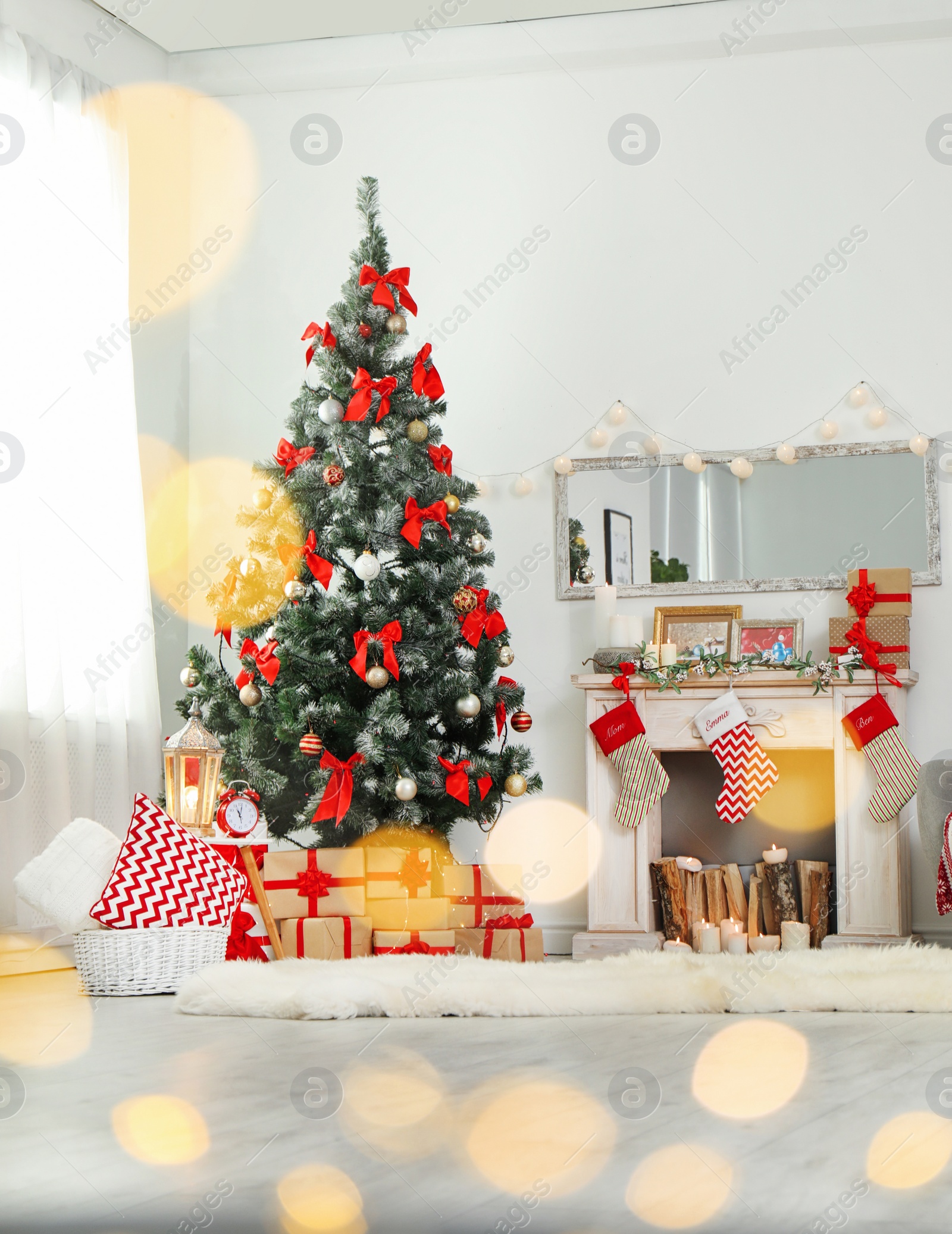 Photo of Stylish living room interior with decorated Christmas tree and blurred lights in foreground