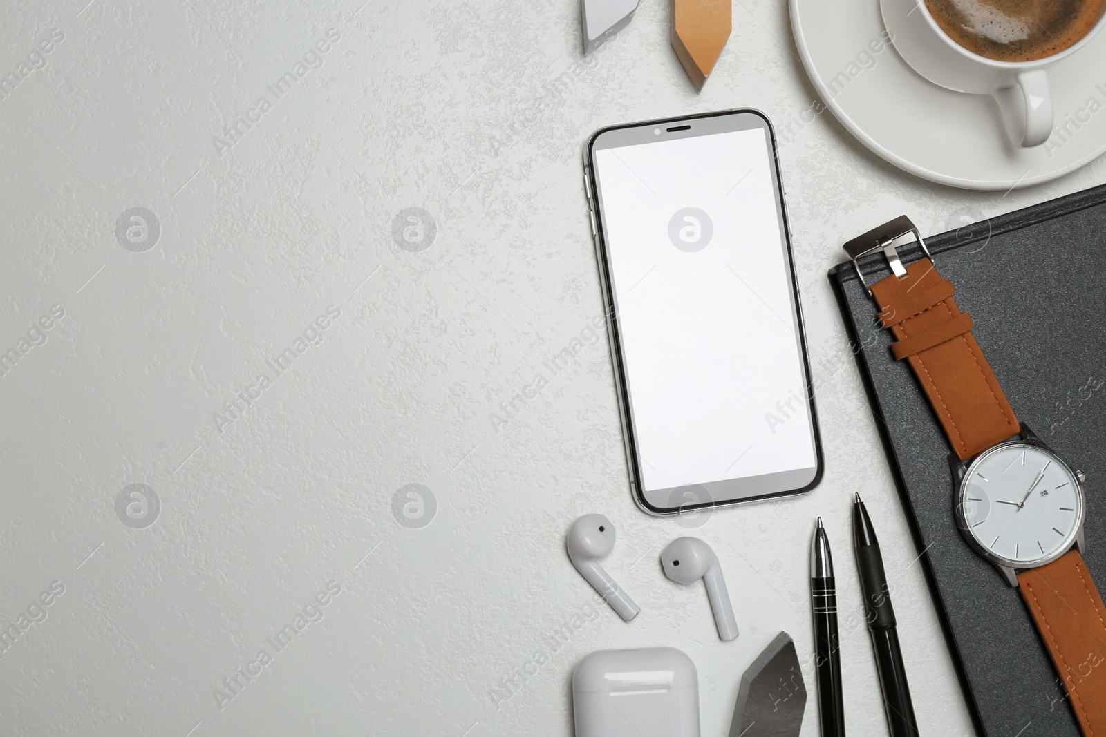 Photo of Flat lay composition with smartphone, cup of coffee and stationery on grey table, space for text