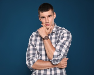 Photo of Portrait of handsome young man on blue background