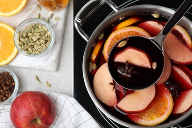 Photo of Delicious hot mulled wine in pot, flat lay