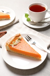 Plate with piece of fresh delicious homemade pumpkin pie on light table