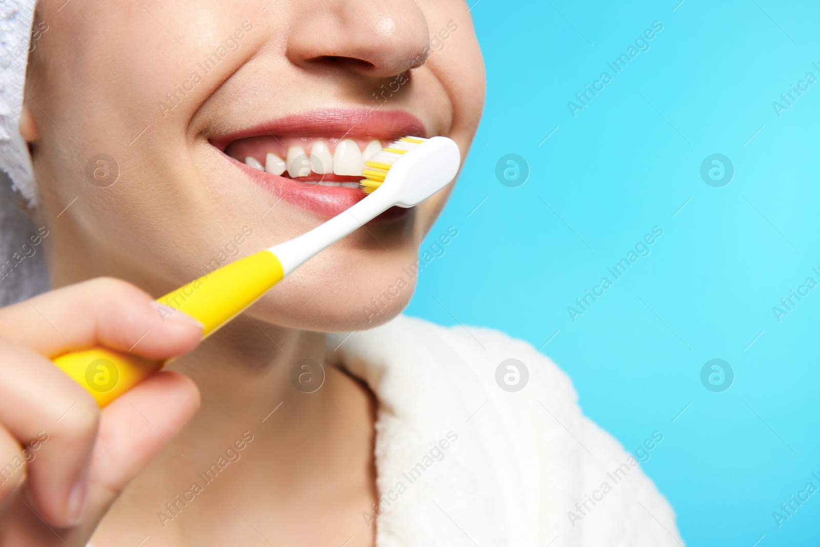 Photo of Young woman with toothbrush on color background, closeup. Space for text