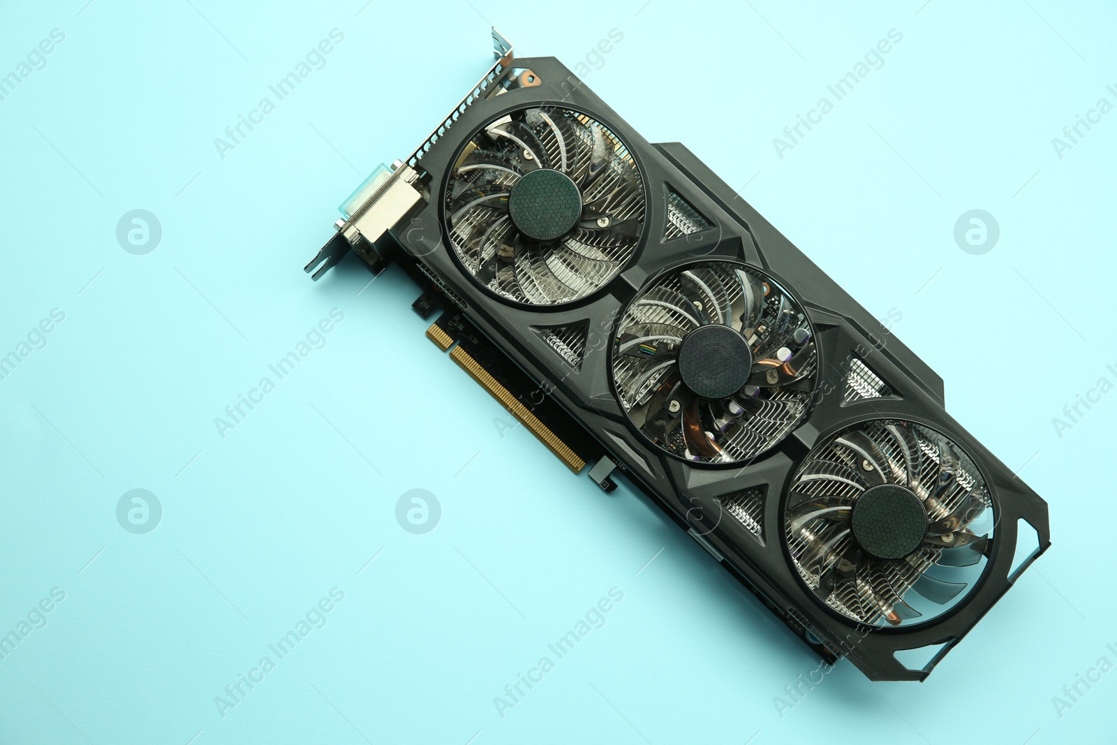 Photo of One graphics card on light blue background, top view. Space for text