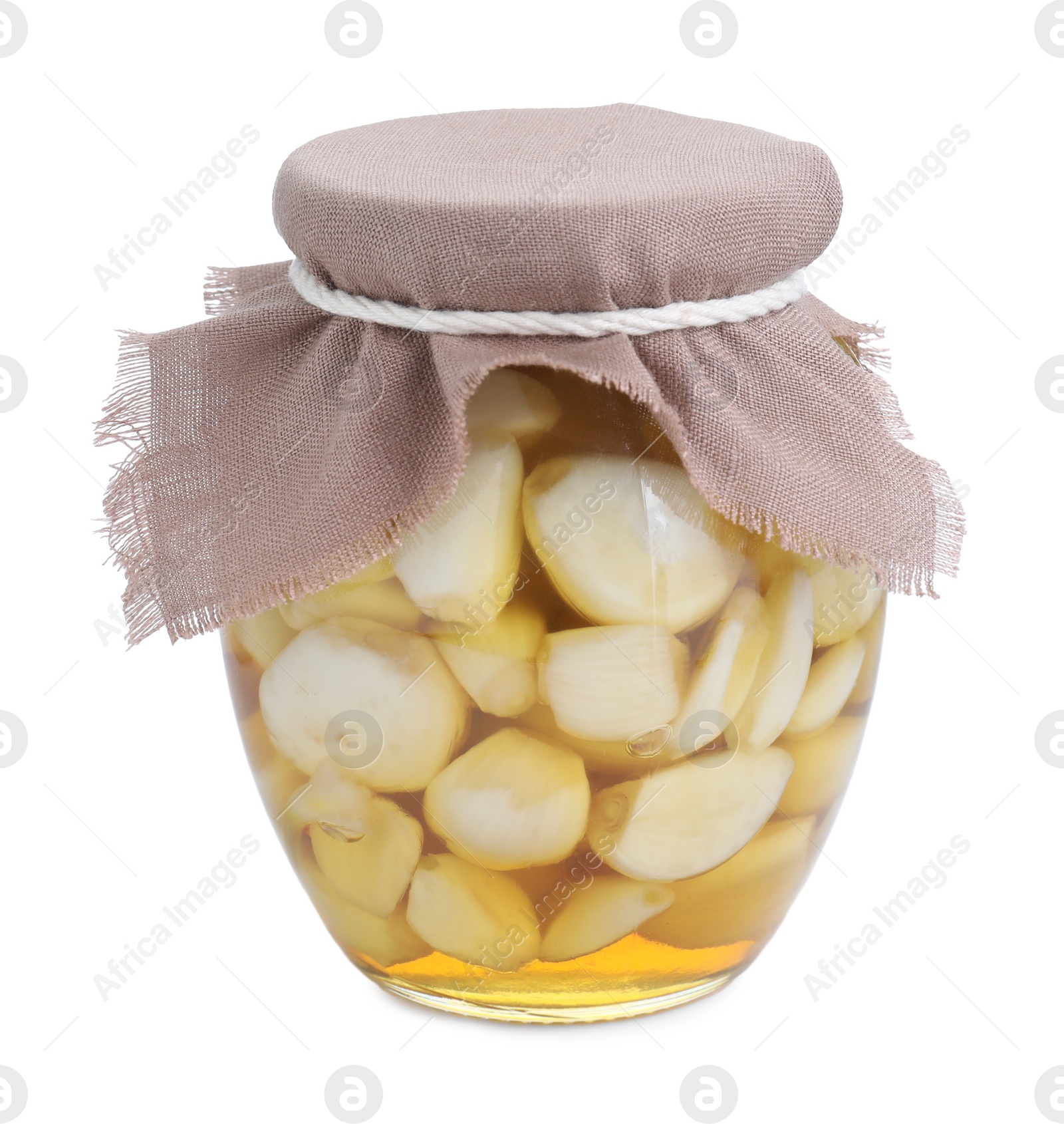 Photo of Garlic with honey in glass jar isolated on white