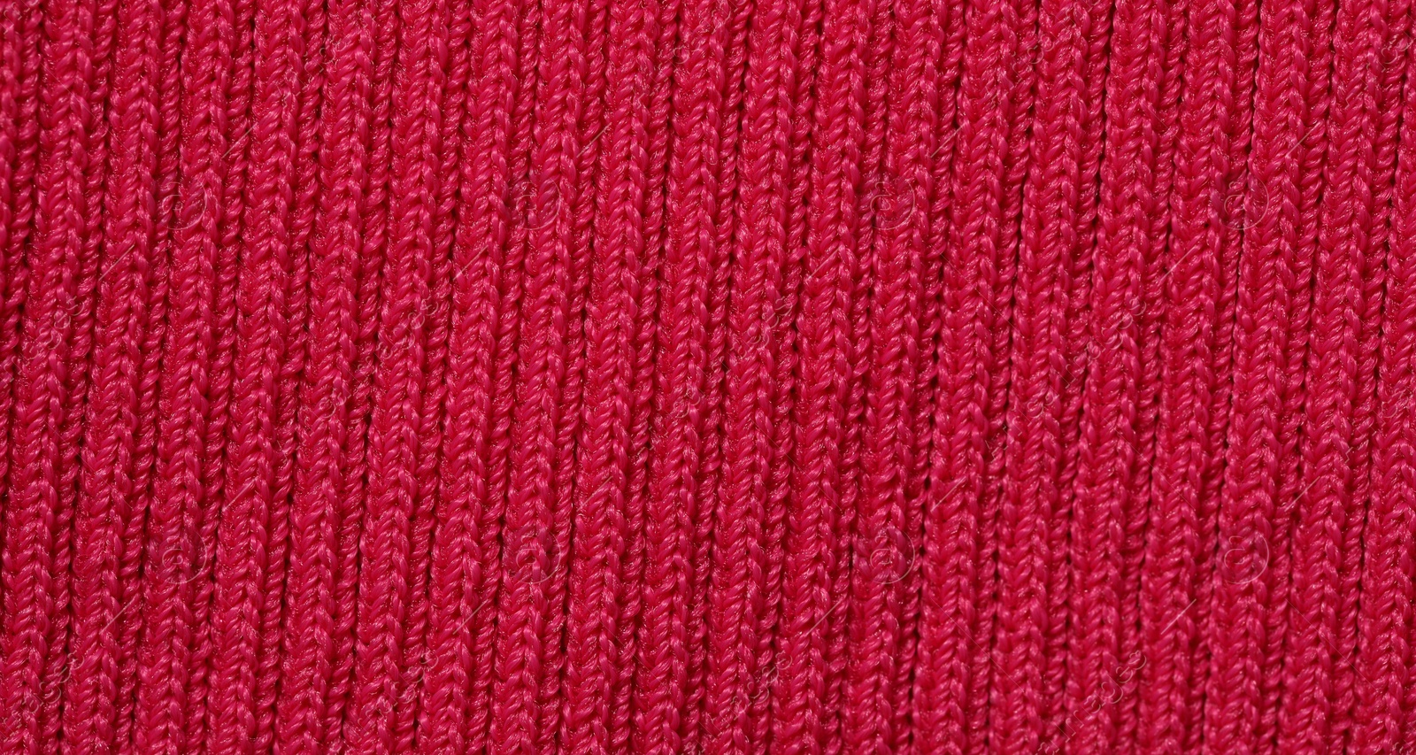 Photo of Texture of soft red knitted fabric as background, top view