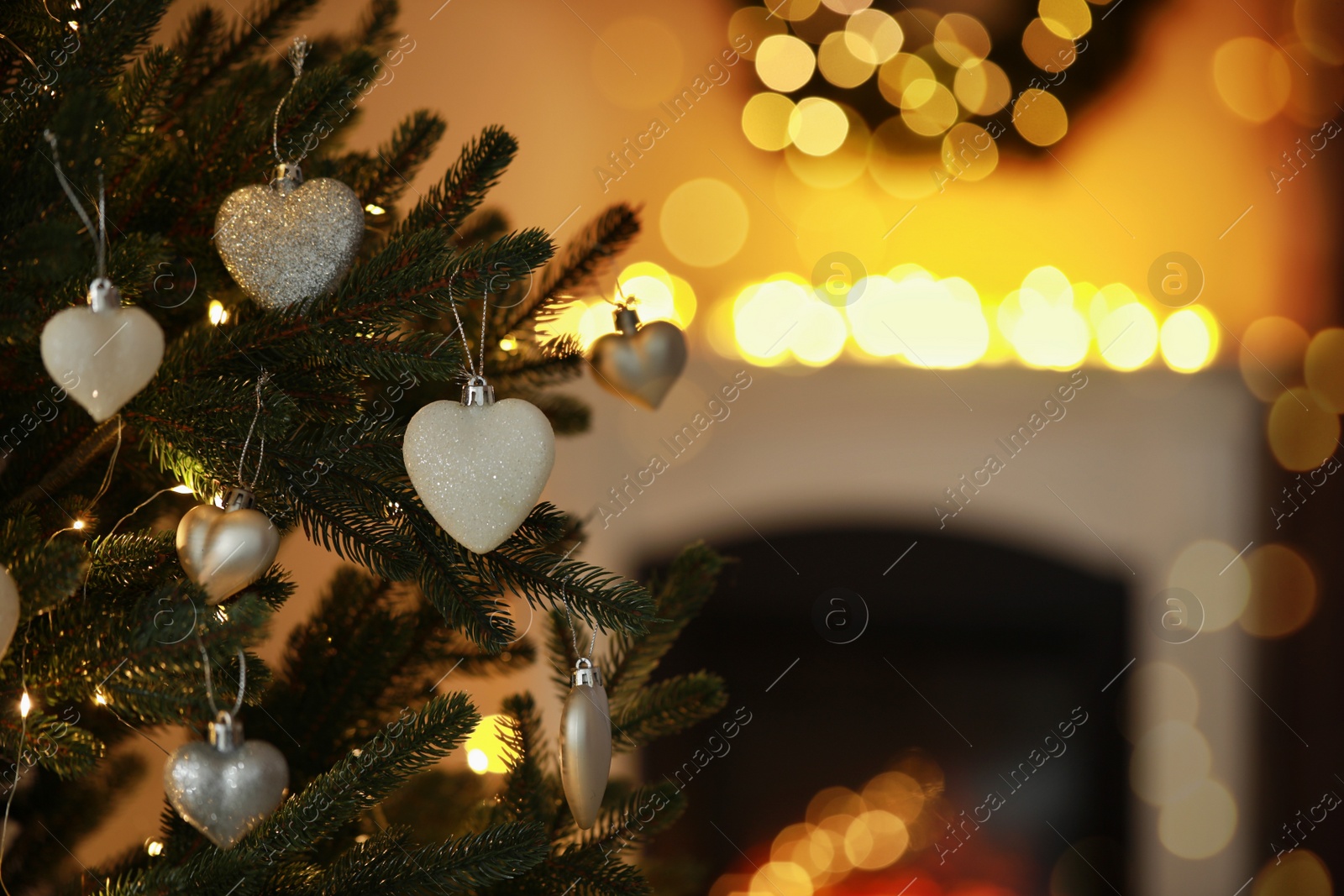 Photo of Beautiful Christmas tree decorated with festive lights and baubles indoors, space for text. Bokeh effect