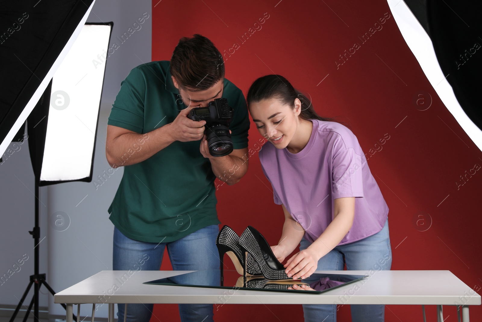 Photo of Professional photographers shooting stylish shoes in studio