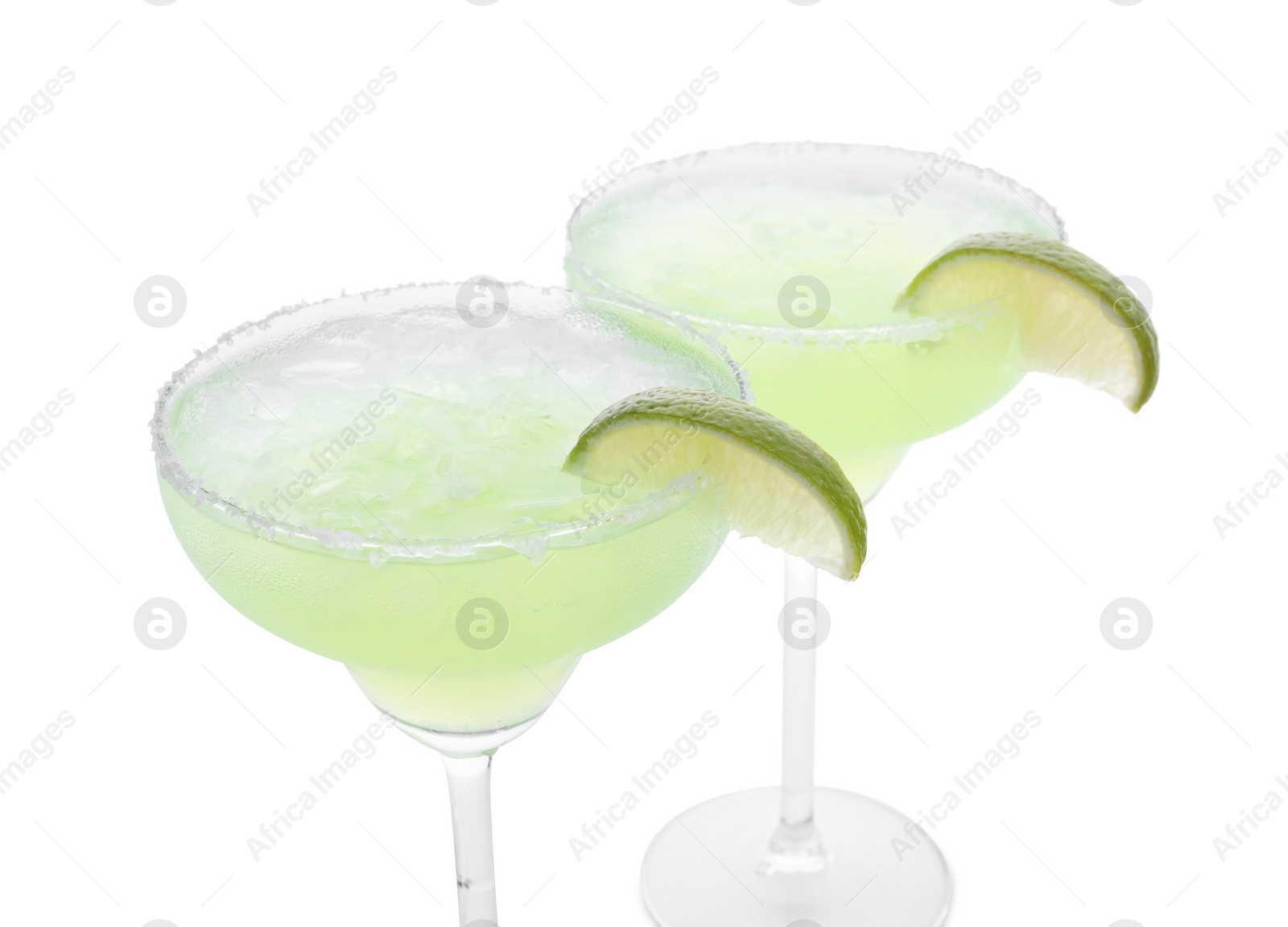 Photo of Delicious Margarita cocktail with ice cubes in glasses, salt and lime isolated on white