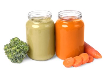 Jars of healthy baby food and fresh vegetables on white background