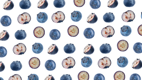 Cut and whole fresh blueberries on white background