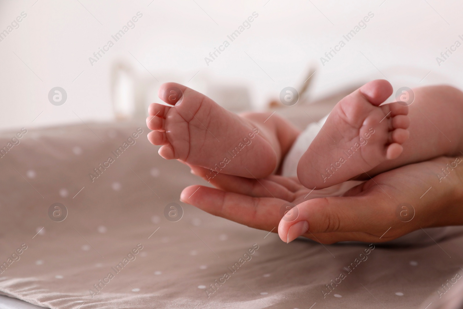 Photo of Mother and her little baby on bed, closeup