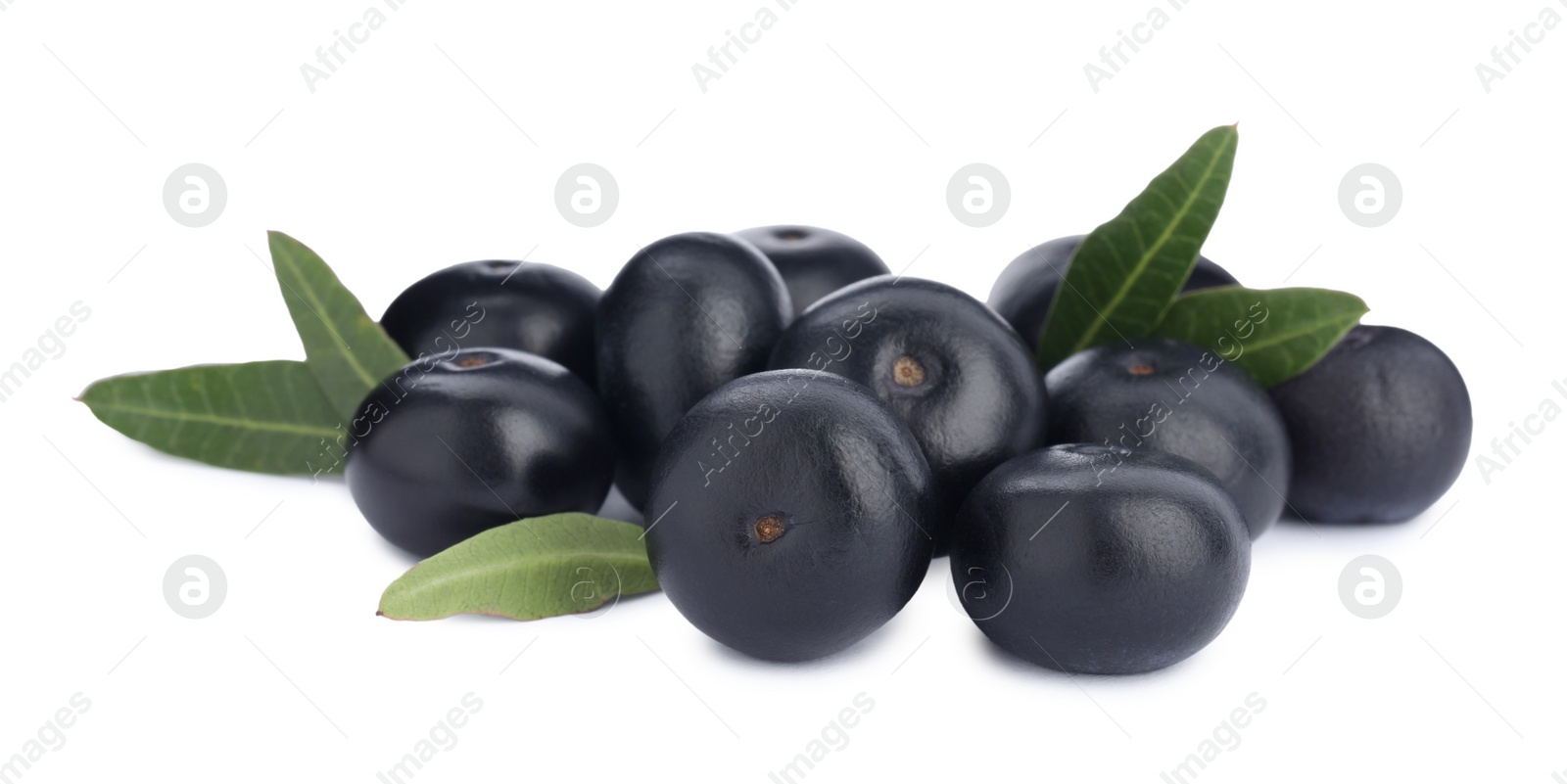 Photo of Pile of fresh ripe acai berries and green leaves on white background