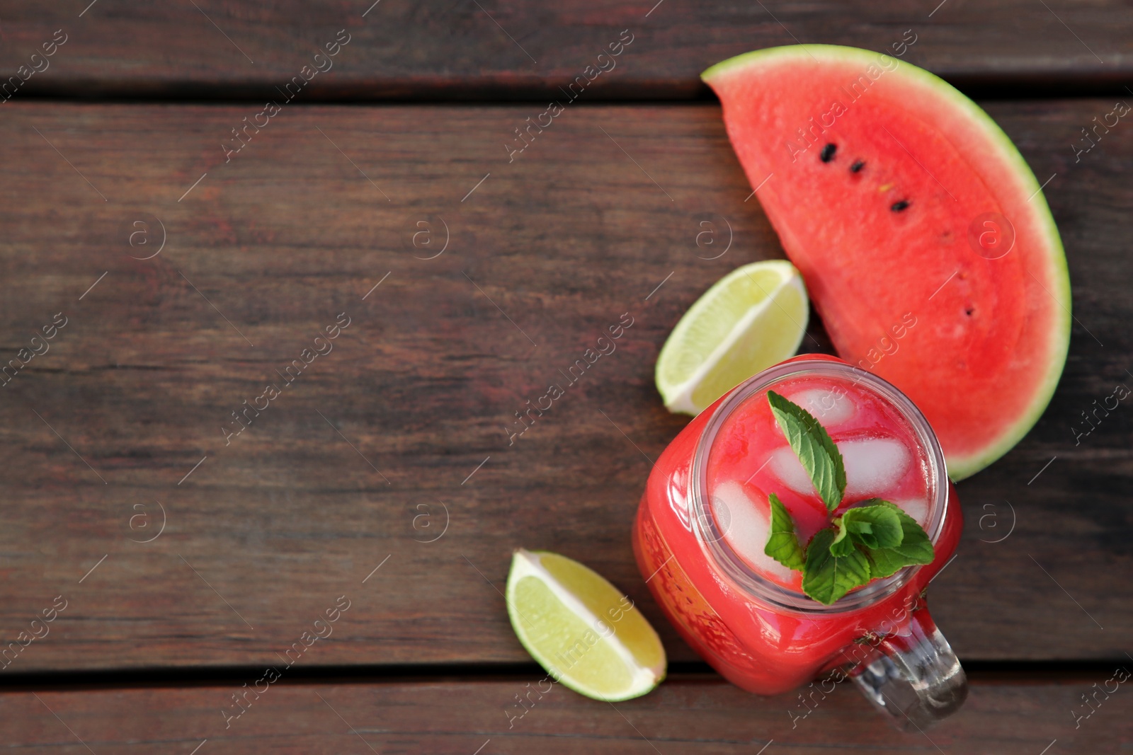 Photo of Delicious watermelon drink and fresh fruits on wooden table, flat lay. Space for text