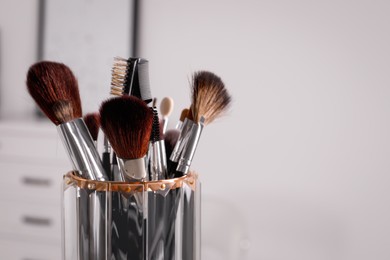 Photo of Set of professional brushes indoors, closeup. Space for text