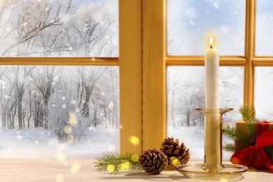 Burning candle, gift box and pine cones on window sill indoors. Christmas eve