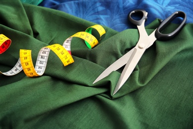 Scissors and measuring tape for tailoring on fabrics