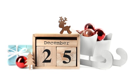 Wooden block calendar and festive decor on white background