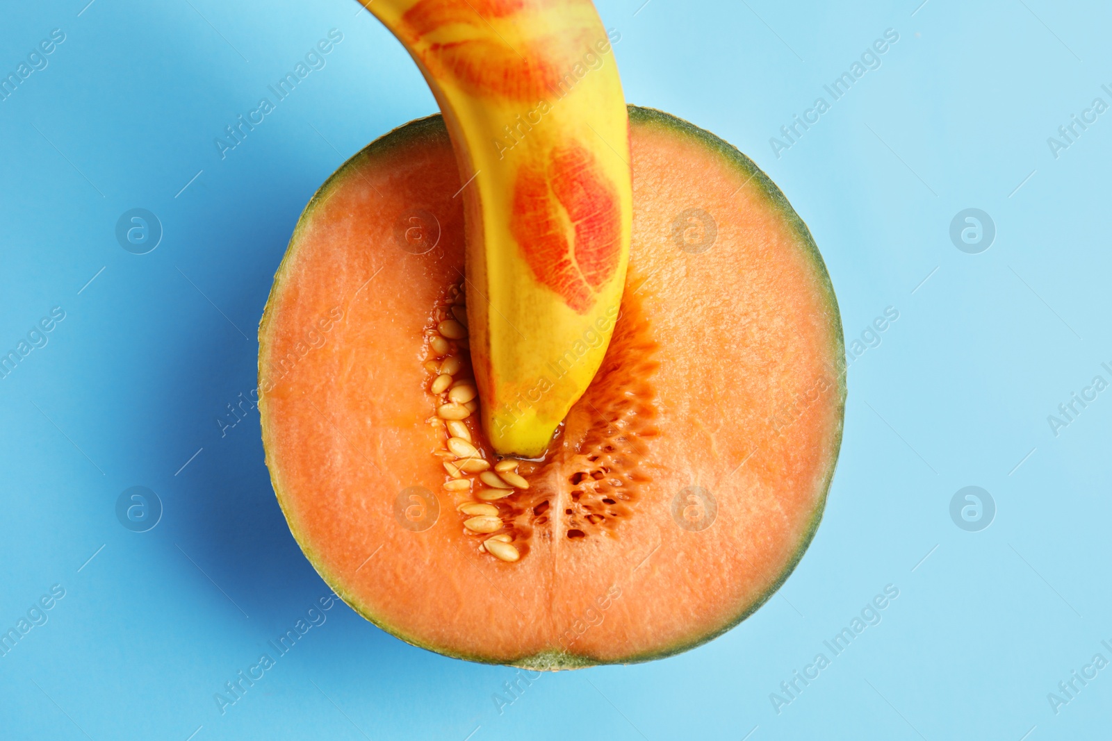 Photo of Flat lay composition with fresh banana and melon on blue background. Sex concept