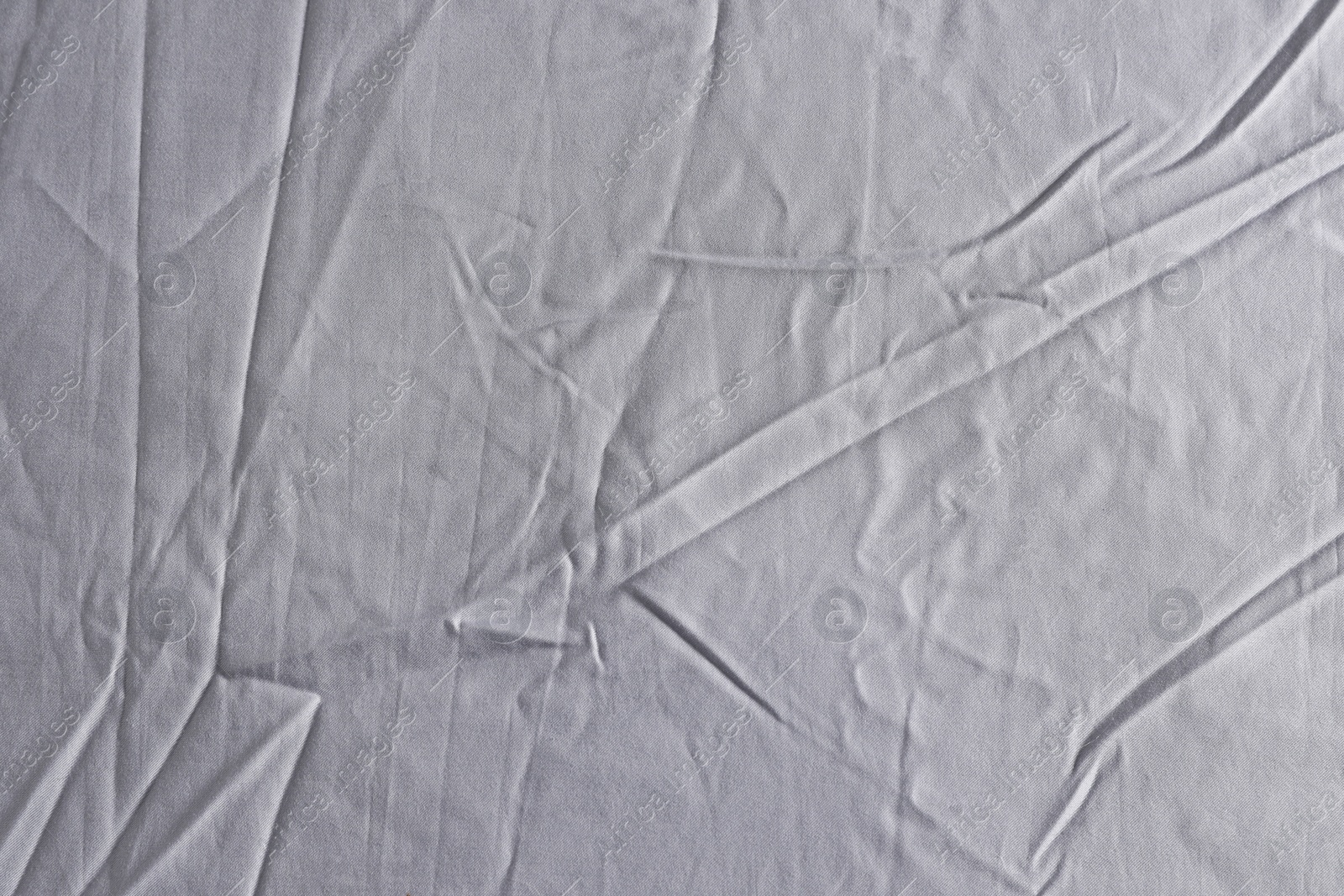 Photo of Crumpled grey fabric as background, top view