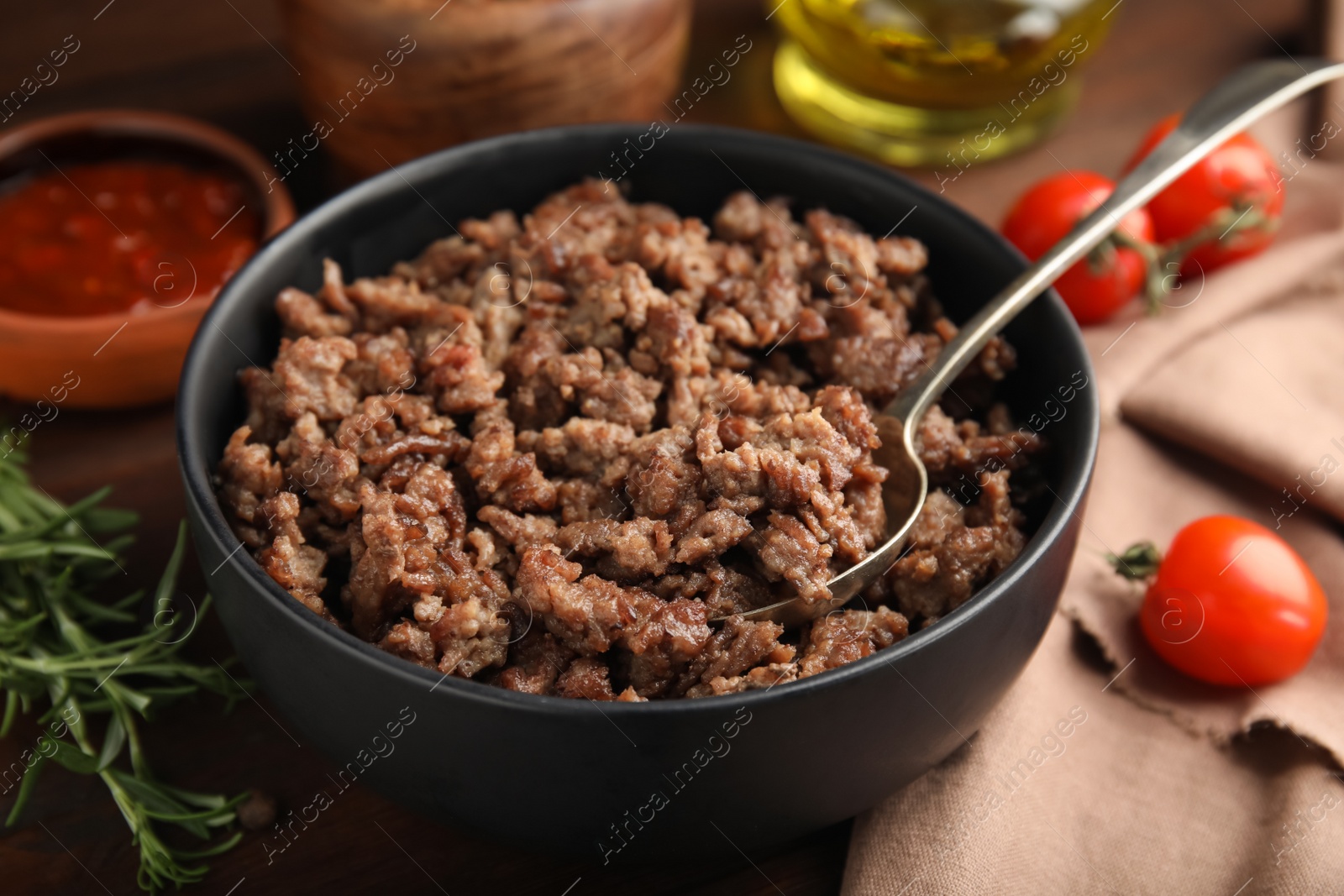 Photo of Fried minced meat and different products on wooden table, closeup