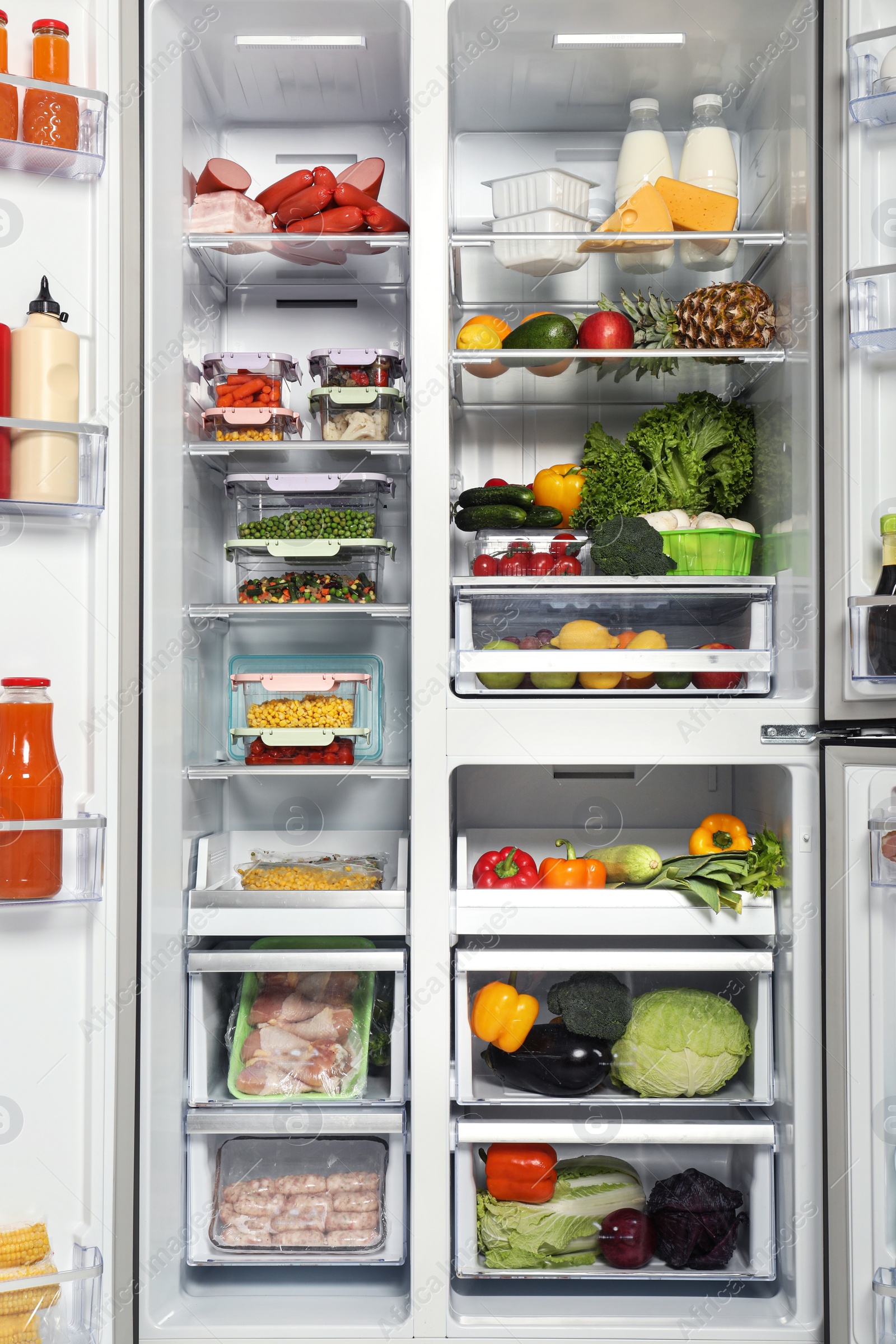 Photo of Open refrigerator full of different fresh products