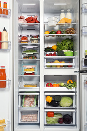 Open refrigerator full of different fresh products