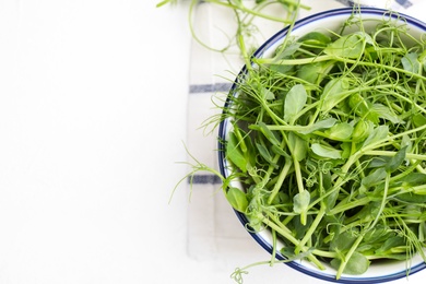 Photo of Fresh microgreen on white table, flat lay. Space for text