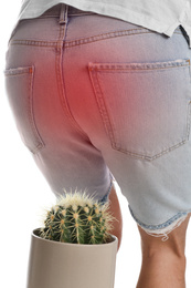 Image of Man sitting down on cactus against white background, closeup. Hemorrhoid concept