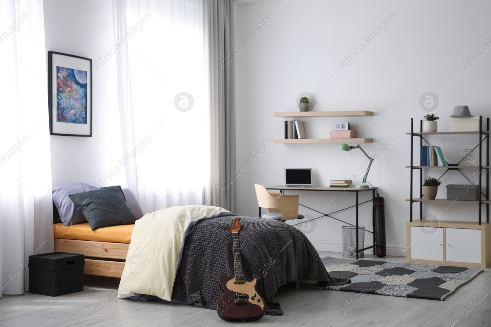 Photo of Modern teenager's room interior with workplace and bed