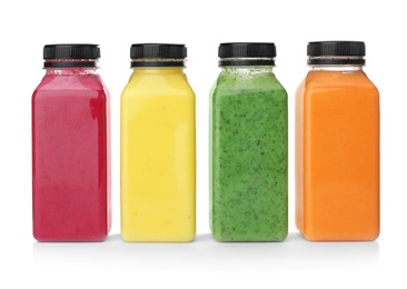 Photo of Bottles with delicious detox smoothies on white background