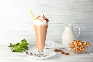 Photo of Glass with delicious milk shake on table