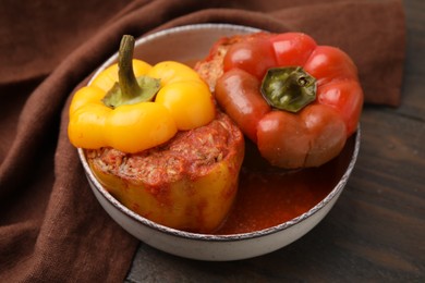 Photo of Delicious stuffed bell peppers on wooden table, closeup