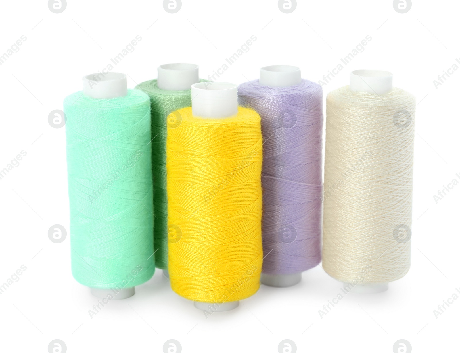 Photo of Set of different colorful sewing threads on white background