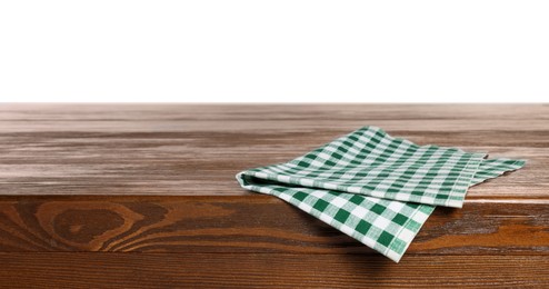 Checkered tablecloth on wooden table against white background